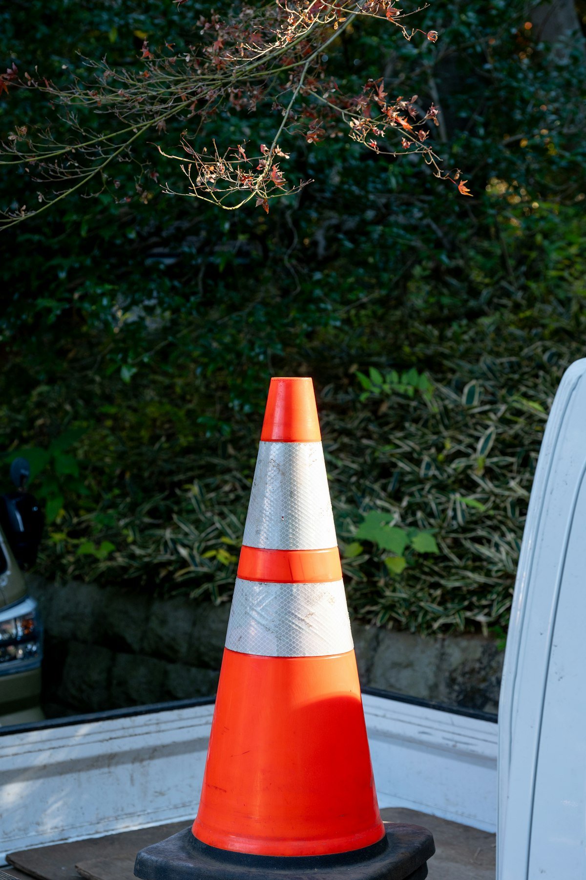 Orange traffic cone with reflective stripes
