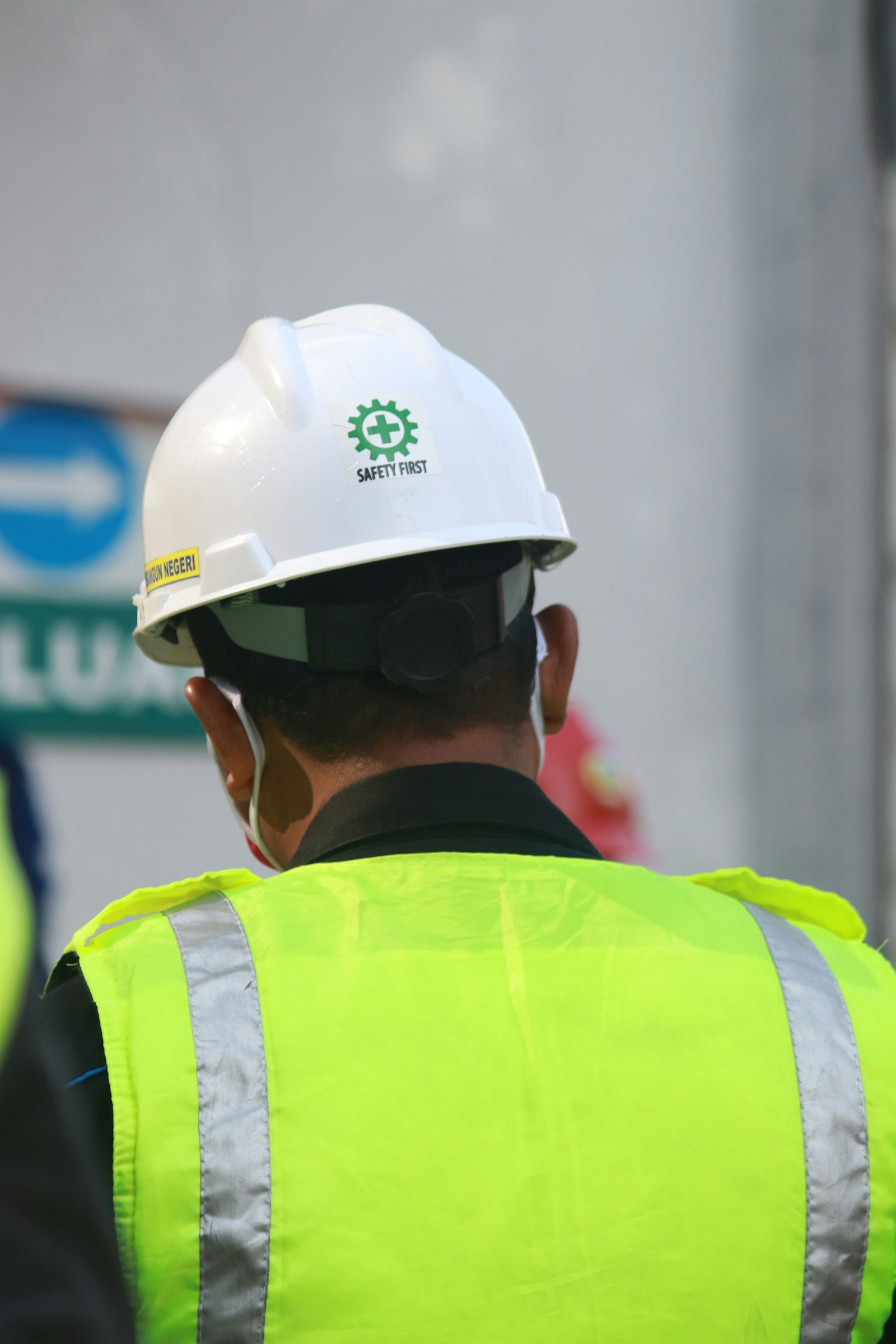 Worker in hi-vis vest and white helmet
