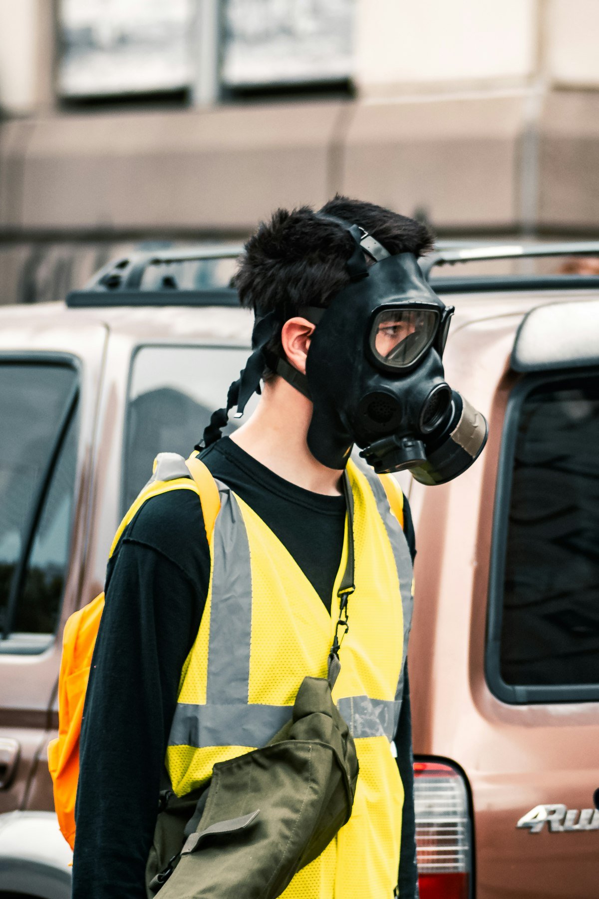 Worker in respirator mask and hi-vis vest