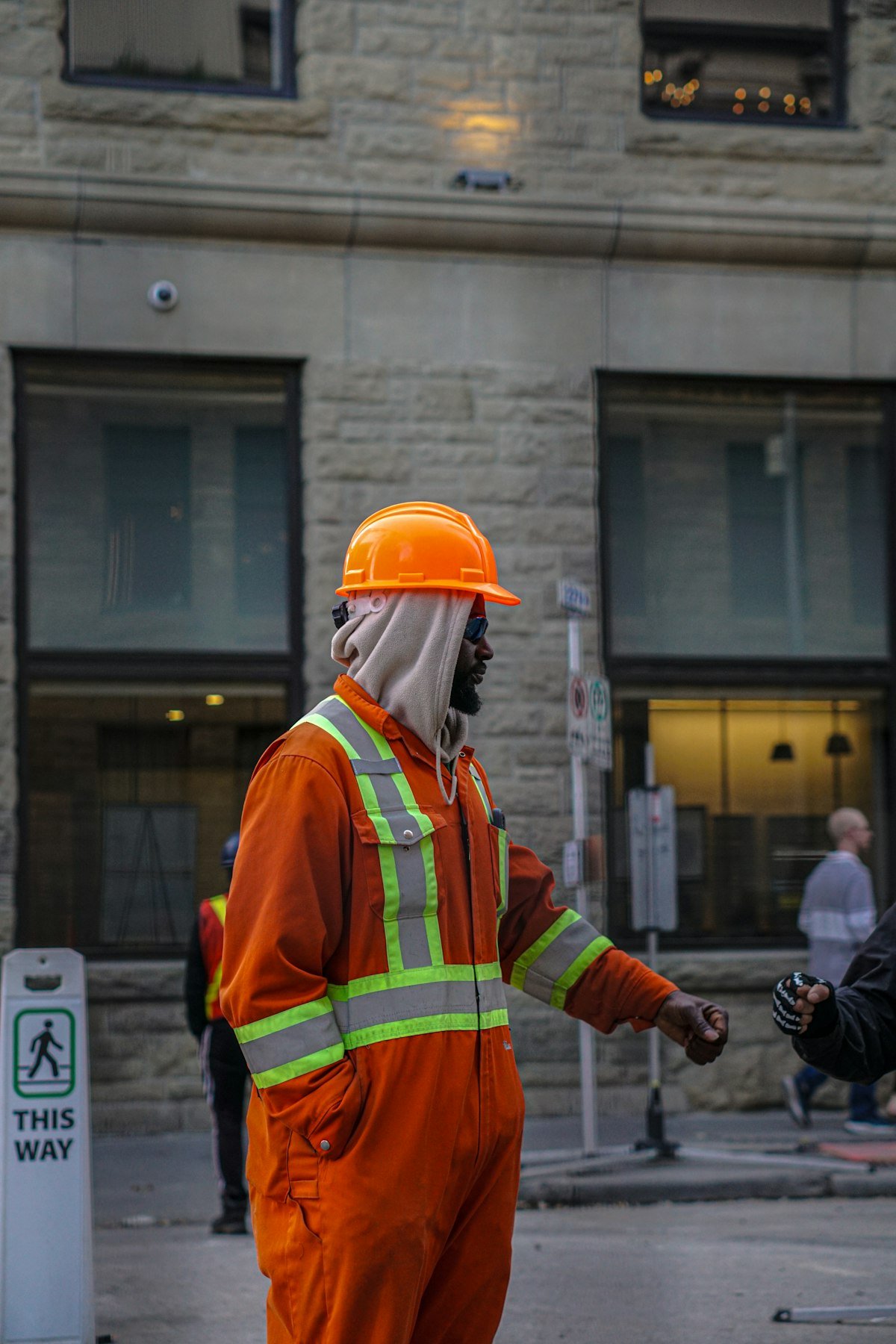 Construction worker in orange workwear and hard hat